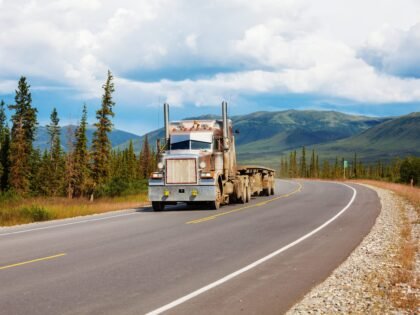 A truck running a highway through open country