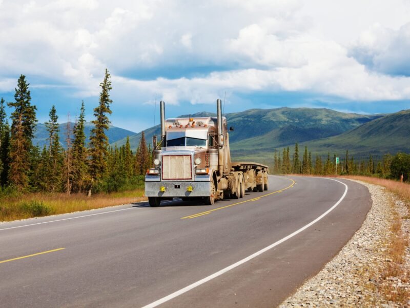 A truck running a highway through open country