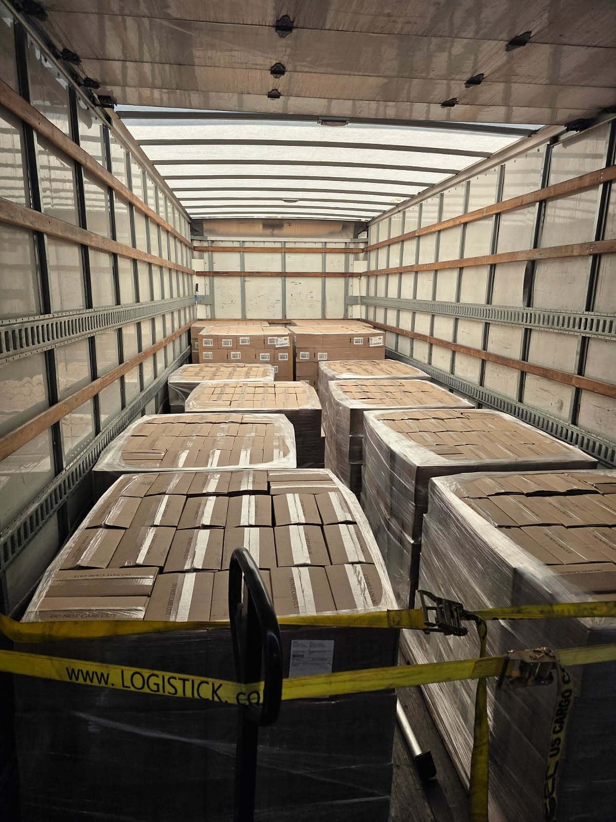 Palletized freight loaded and strapped inside a dry van