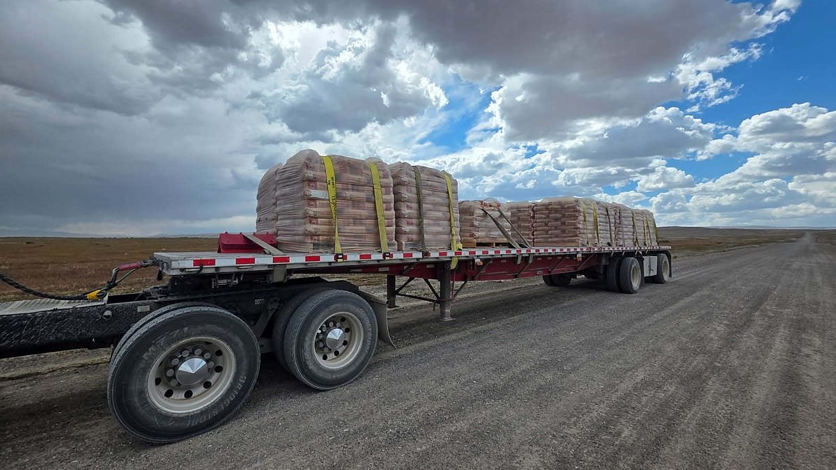Palletized freight loaded on an open flatbed trailer
