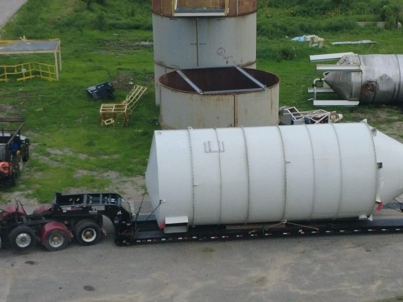 Industrial silo secured on a lowboy trailer