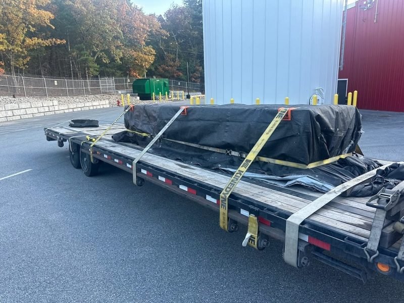 Tarped and strapped load on a stepdeck trailer